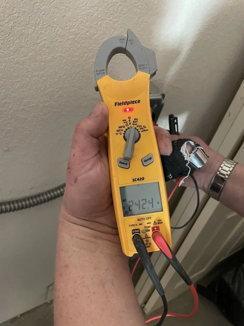 Voltage testing with clamp meter during Electrical Installation Services in Fort Stewart